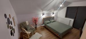 a bedroom with a bed and a chair in a room at Matei Rent Apartments - Premium Stays & Free Parking in Baia Mare
