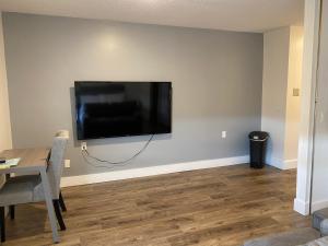 a living room with a flat screen tv on a wall at Lovely Micro Studio Apartment in Downtown Gadsden in Gadsden