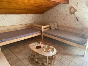 a room with two bunk beds and a table at Stemicar dans les Landes in Lesperon