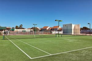 a tennis court with two tennis nets on it at Summer House 703B by ALBVR - Great Beachfront Condo with Oversized Balcony & Amazing Views! in Orange Beach