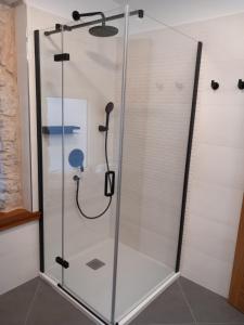 a shower with a glass enclosure in a bathroom at Hidden Heritage in Skradin