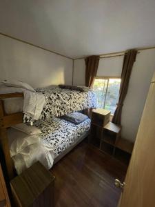 a small bedroom with a bed and a window at El Chiflon Un Lugar de Ensueño in Puerto Rico