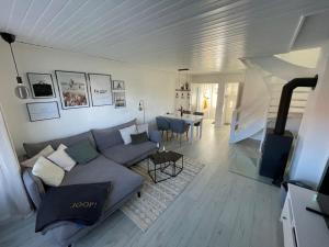 a living room with a couch and a table at Nordseetraum - Ferienhaus Wolke in Friedrichskoog