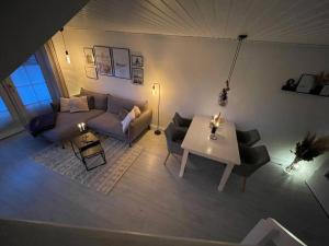 a living room with a couch and a table at Nordseetraum - Ferienhaus Wolke in Friedrichskoog