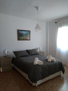 a bedroom with a bed with two towels on it at MARIANS in Salobreña