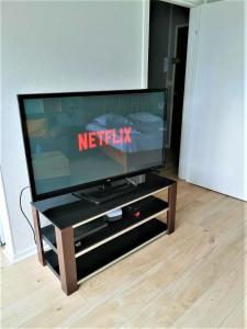 a flat screen tv sitting on top of a entertainment center at Khara - SILS in Caen