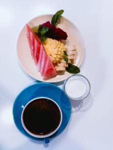 a plate of food next to a bowl of coffee at Cosè Gili Beach Resort in Gili Trawangan