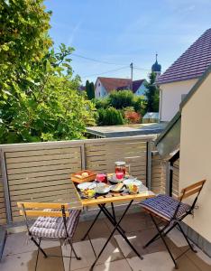 a table with bowls of food on a balcony at Ruhige 2-Zimmer Ferienwohnung FeWo Bodensee in Öhningen