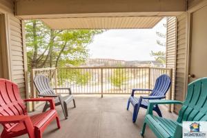 a porch with rocking chairs and a balcony with a view at 2BR Walk-In Condo - Near the 76 Strip - 2 Pools - FREE TICKETS INCLUDED - FHD-8 in Branson