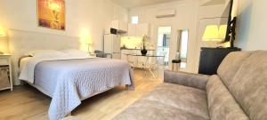 a living room with a bed and a couch at SeaYouSoon Inn Cannes - Studios in Cannes +77 photos