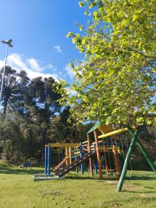 a park with a playground with a slide at Chalés Alpes do Vale- Gramado in Gramado