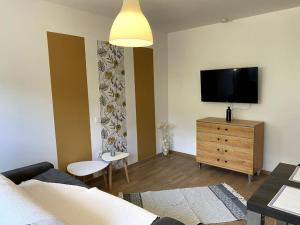 a living room with a couch and a flat screen tv at Studio Genovese in Ajaccio