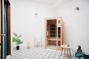 a room with a white wall and a table at Vista Napoli Residence by Casa Napoletana in Naples