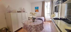 a kitchen with a table with a vase on it at SeaYouSoon Inn Cannes - Studios in Cannes