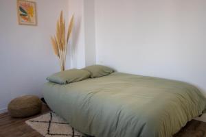 a bed with two pillows on it in a room at Beautiful Apartment 200m from Beach in Canet-en-Roussillon