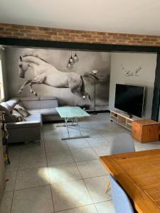 a living room with a horse mural on the wall at Lapeyre in Lignan-de-Bazas