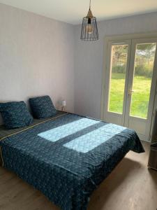 a bedroom with a large bed with a blue comforter at Lapeyre in Lignan-de-Bazas +9 photos