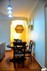 a dining room with a table and two chairs at Elegant 2bedroom apartments close to city center in Kampala