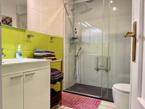 a bathroom with a shower and a sink and a toilet at Apartment on the beach with parking and pool in Calpe