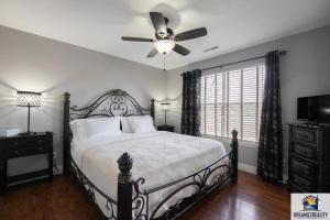 a bedroom with a bed with a ceiling fan at 2BR Walk-In Condo - Near the 76 Strip - Free WIFI - Pool - FREE TICKETS INCLUDED - CLB-3 in Branson