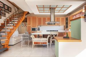 a kitchen with a staircase and a living room at Family Villa Ellis Plakias with private pool 200m to the beach walking distance to the amenities in Plakias