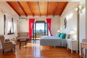 a bedroom with a bed and a view of the ocean at Family Villa Ellis Plakias with private pool 200m to the beach walking distance to the amenities in Plakias