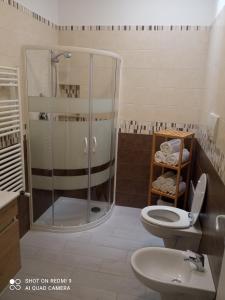 y baño con ducha, aseo y lavamanos. en Carone home en Mola di Bari