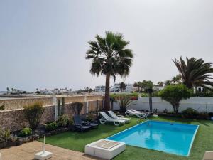 Piscina y Relax junto al Mar! في كوراليخو: مسبح في ساحة فيها نخيل