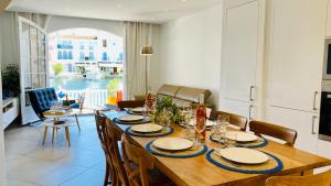 a dining room with a wooden table and chairs at Maison de pêcheur Strelitzia amarrage 3,8m par 16m in Grimaud +26 photos