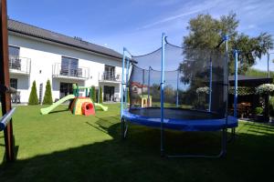 a playground with a trampoline in a yard at Villa Bueno Bis in Rowy
