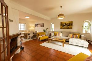 a living room with a couch and a table at Spacious 3 bedroom house w/ swimming pool in Ericeira