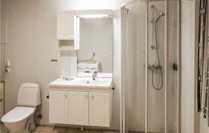 a bathroom with a toilet and a sink and a shower at Holiday Home Finnås Lyklingsjøvegen in Lykling