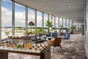 a lobby with a table with drinks and chairs at Tampa Airport Marriott in Tampa
