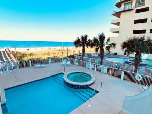 a resort with a swimming pool and the beach at Crystal Shores 1301 by ALBVR - Beautiful Beachfront Corner Condo with Gorgeous Views! in Gulf Shores