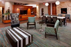 a lobby with a dining room with a table and chairs at Residence Inn by Marriott San Antonio Six Flags at The RIM in San Antonio