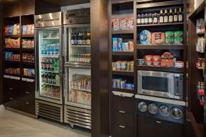 a kitchen with a refrigerator and a microwave at Courtyard Fort Worth I-30 West Near NAS JRB in Fort Worth