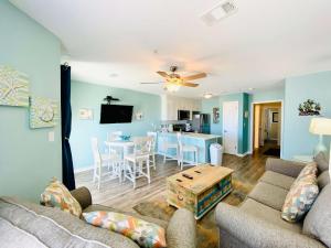 a living room with a couch and a table at Grand Beach 315 by ALBVR - Come relax at our beautiful condo in the heart of Gulf Shores! in Gulf Shores