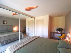a bedroom with a bed and a mirror at Mama Fox in Alepou