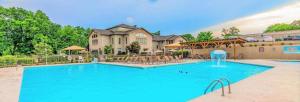 a large swimming pool in front of a house at 1BR Walk-In Condo at Pointe Royal - 2 Pools - FREE ATTRACTIONS TICKETS INCLUDED -PR40-9 in Branson