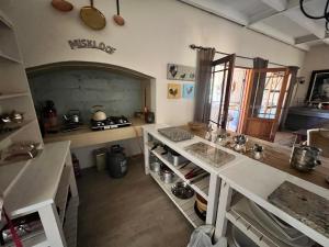 a kitchen with white counters and a counter top at Miskloof Farm in Matjiesrivier