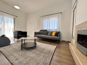 a living room with a couch and a fireplace at New Heaven in Sea Caves in Peyia