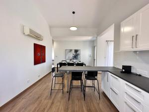 a kitchen with a table and chairs in a room at New Heaven in Sea Caves in Peyia