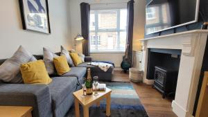 a living room with a couch and a fireplace at Colenso St - 2 bed house by Bishy Road & River in York