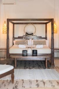 a bed with a wooden frame in a room at Hotel Can Sastre in Santa Gertrudis de Fruitera