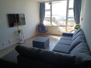 a living room with a couch and a large window at Sun Sea Sand Peacehaven Scottburgh in Scottburgh