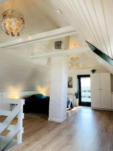 a living room with a bed and a vaulted ceiling at Hus på 100 m2 ved skov in Hårlev