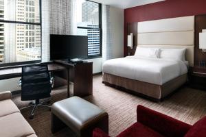 a hotel room with a bed and a desk with a computer at Residence Inn by Marriott Chicago Downtown/Loop in Chicago