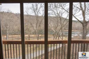 a view from a screened in porch with a window at 3BR Condo with Lake View - Trout Fishing - Playground - 2 Pools - FREE TICKETS INCLUDED - PR69-9 in Branson