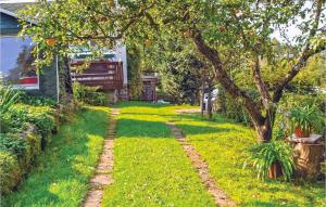 a garden with an orange tree and a walkway at Beautiful Home In Ehrenberg With Wifi in Ehrenberg