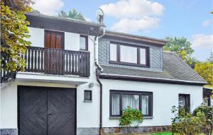 a white house with a black garage at Beautiful Home In Ehrenberg With Wifi in Ehrenberg